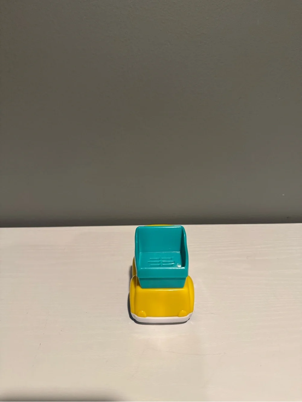 Yellow & Teal Kids Dump Truck Toy - Cute Face Design. Lights up and makes sounds